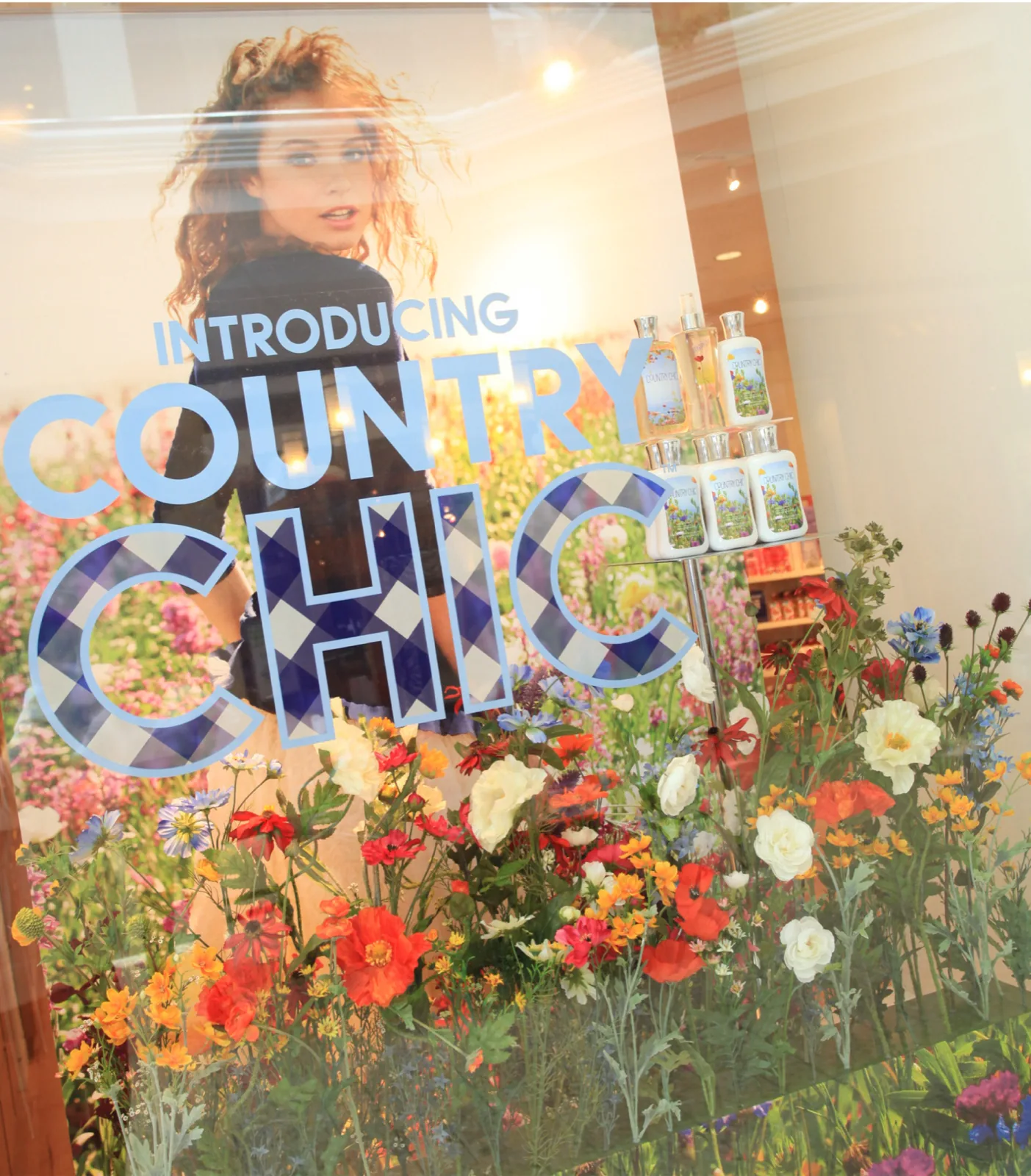 The launch window, the campaign image behind a bank of real wildflowers