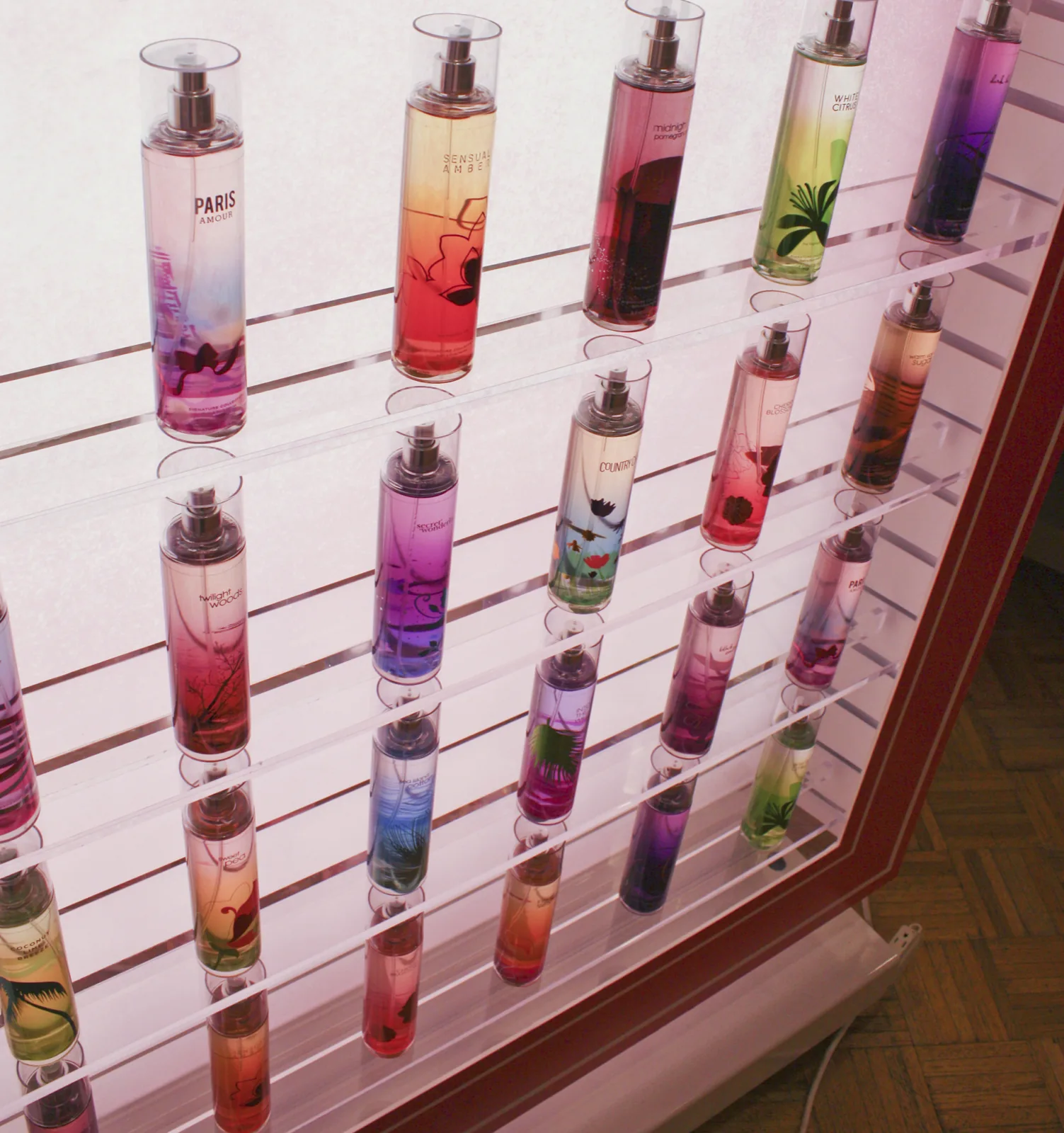 The mist wall, forty bottles racked in a colour gradient across four shelves