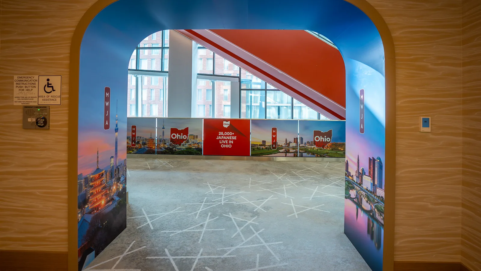 A wooden archway wrapped inside and out, Japanese and Ohio cityscapes meeting at the opening