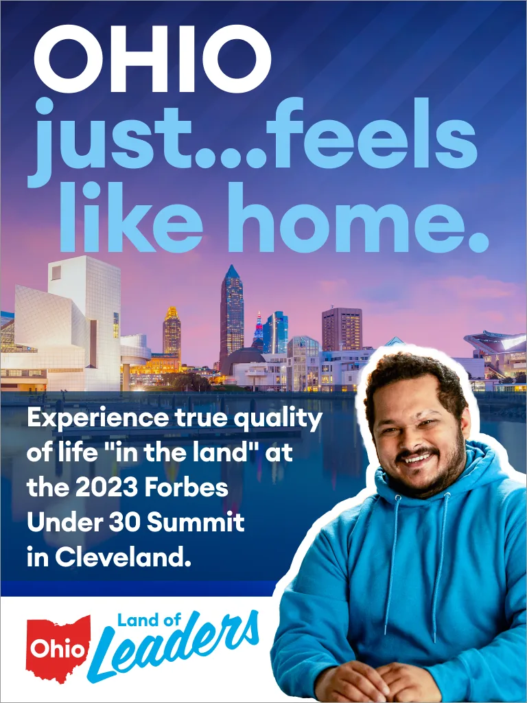 Vertical ad, a man in a blue hoodie cut out against the Cleveland skyline at dusk